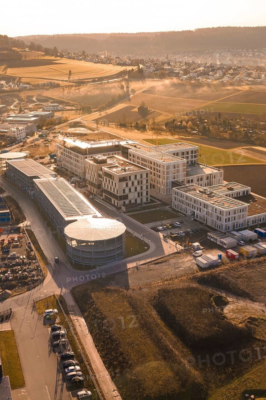 Industrial complex with modern buildings in a rural area with fields, new hospital at the Calw health campus, Calw district, Germany