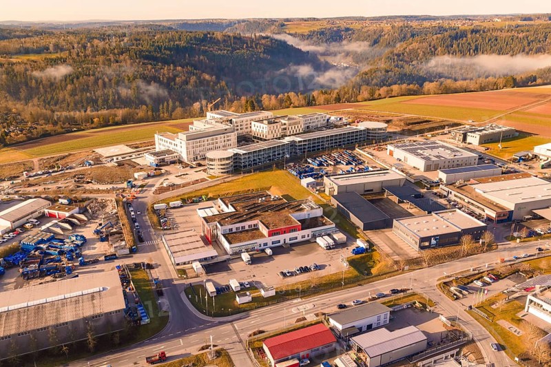 Industrial area surrounded by forest and hills with urban features, new hospital at Calw Health Campus, Calw district, Germany