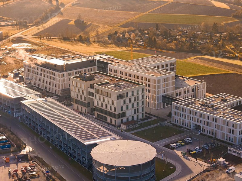 Modern buildings in a rural region with fields and autumn sounds in the evening light, new hospital at the Calw health campus, Calw district, Germany