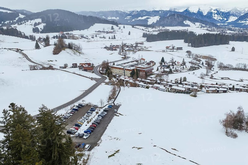 Snowy mountain village surrounded by hills and roads from a bird's eye view, specialist clinic for psychosomatics and psychotherapy, Hochgrat Clinic, Stiefenhofen, Bavaria, Germany