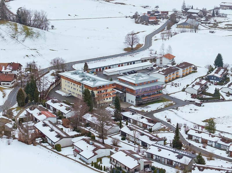 Snowy village with views of roofs and roads from above, specialist clinic for psychosomatics and psychotherapy, Hochgrat Clinic, Stiefenhofen, Bavaria, Germany