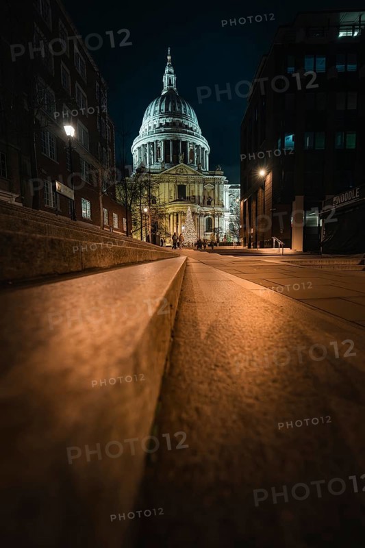 Night view of St. Paul's Cathedral from a quiet street with lights, London, United Kingdom