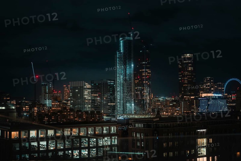 Illuminated skyline of London at night with modern skyscrapers in the foreground, London, United Kingdom