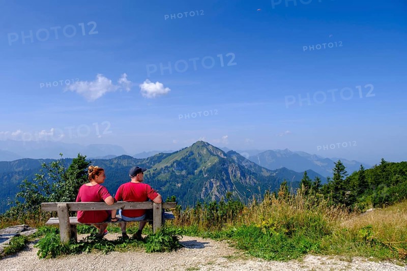 Hikers, mountaineers on a rest bench, in the summit area, at Hochfelln, near Bergen, Chiemgau, Upper Bavaria, Bavaria, Germany