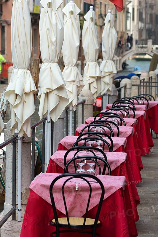 Tables set on the canal of a restaurant, Venice, Veneto, Italy