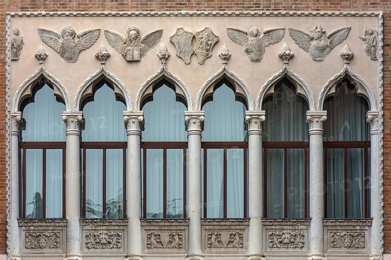 Decorative window front with reliefs of a palazzo, Venice, Veneto, Italy