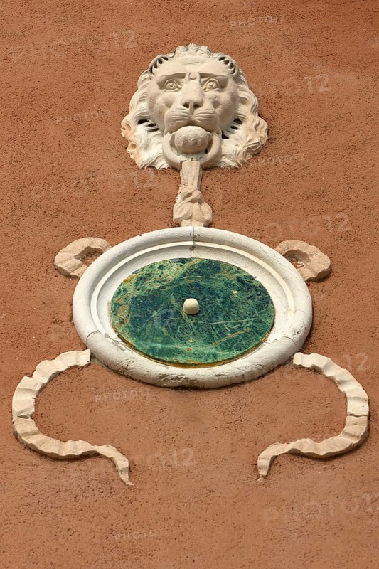 Relief of a lion's head on a house wall, Venice, Veneto, Italy