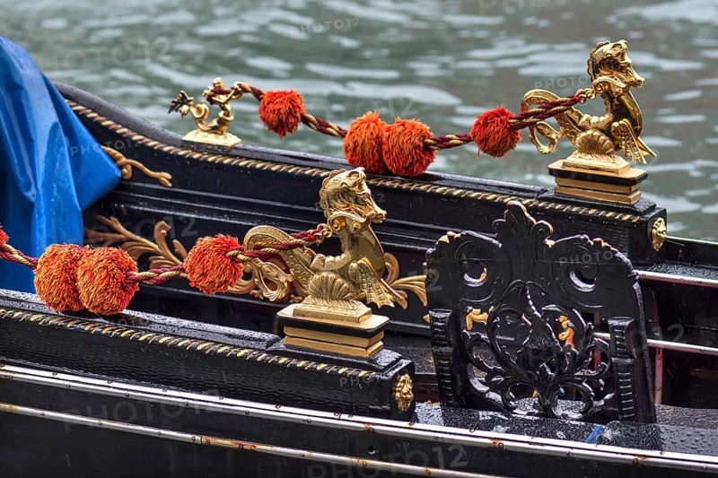 Gold-colored mythical animals decorate the gondola, Venice, Veneto, Italy