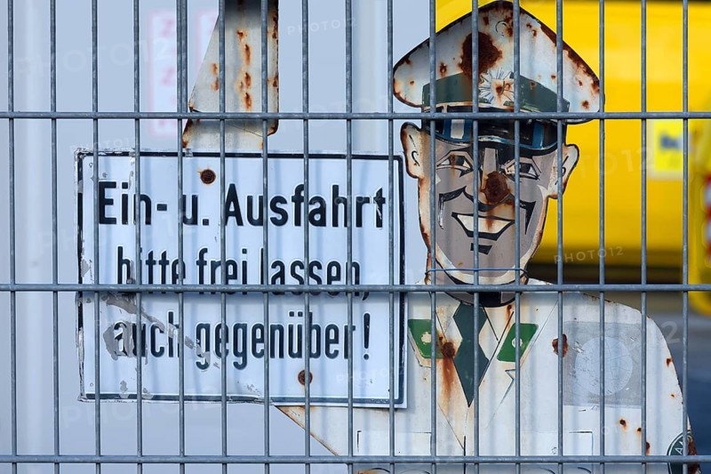 1950s traffic police officer metal sign behind a wire fence, Bavaria, Germany