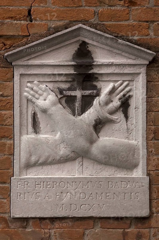 Memorial plaque with crossed hands on a house wall, Venice, Veneto, Italy