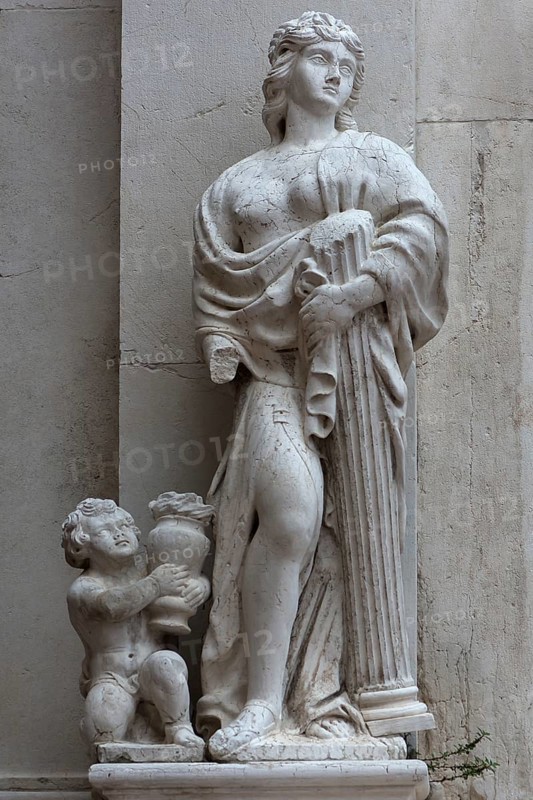 Female sculpture with a column in her arms, Venice, Veneto, Italy