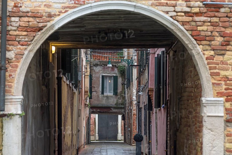 View of an alley in the old town through an archway, Venice, Veneto, Italy