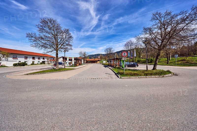 Inzell bus station, parking lot with cars, general architecture, residential buildings, bare winter trees, hilly landscape, coniferous forest, blue sky, cirrus clouds, cirrostratus clouds, Traunsteiner Straße, Inzell, Traunstein district, Bavaria, Germany