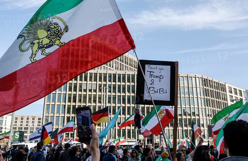 Iranians demonstrate on the day of the US and Israeli attack on Iran in Berlin, 28.02.2026. A poster says Tahnk you Trump and Bibi, Berlin, Germany