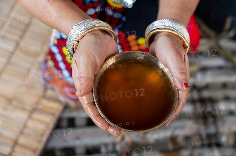 A Mising tribal woman shows their traditional rice beer 'Aapong' during Ali-Aye-Ligang festival in Guwahati, Assam, India on 18 February 2026. Ali-Aye-Ligang celebrates the Mising community's sowing season with traditional dance, rituals, feasting, and prayers for a prosperous harvest
