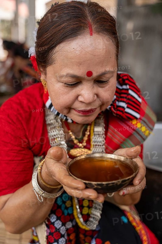 A Mising tribal woman having traditional rice beer 'Aapong' during Ali-Aye-Ligang festival in Guwahati, Assam, India on 18 February 2026. Ali-Aye-Ligang celebrates the Mising community's sowing season with traditional dance, rituals, feasting, and prayers for a prosperous harvest