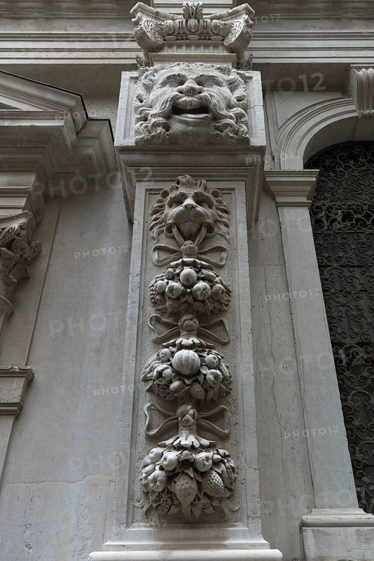 Fruit and animal sculptures on a pillar of a church, Venice, Veneto, Italy