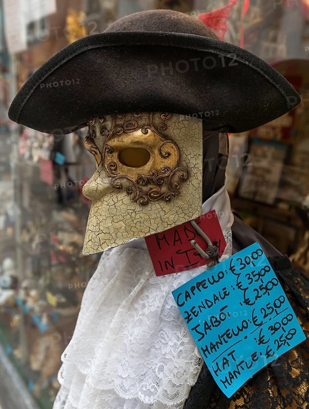 Venetian mask with sales offer in front of a shop, Venice, Veneto, Italy