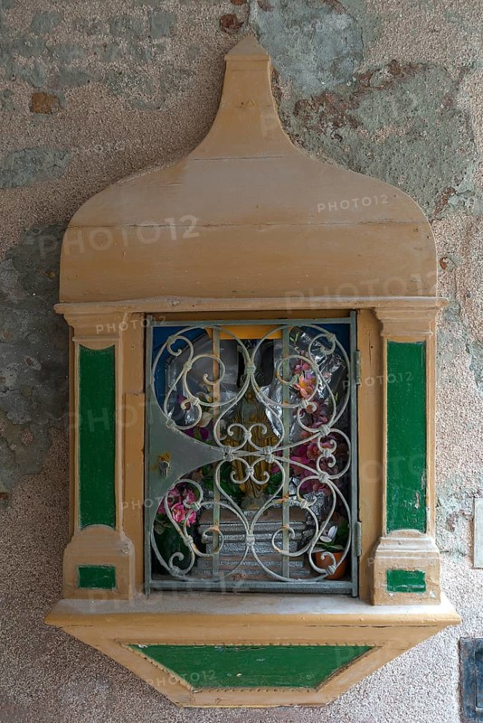 Holy shrine with the figure of Jesus Christ on a house wall, Venice, Veneto, Italy
