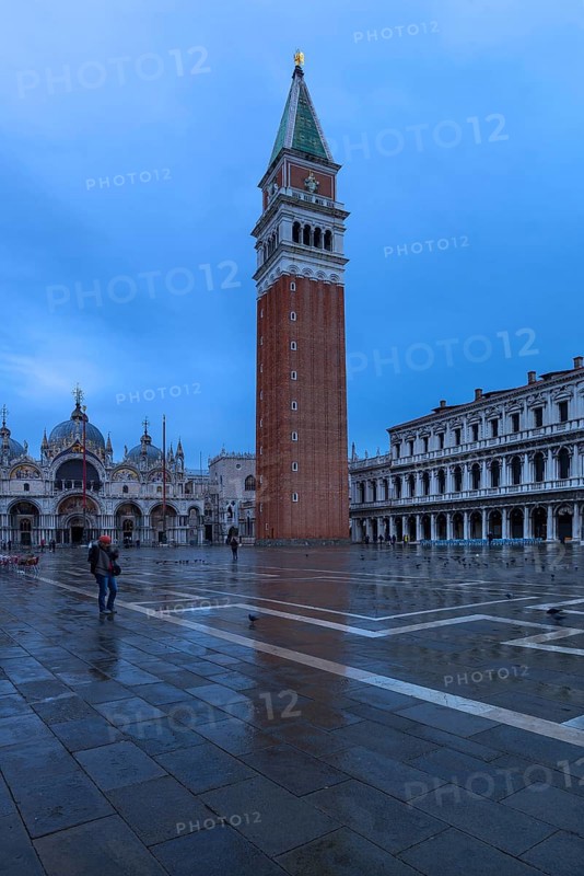 Empty St. Mark's Square with arcades of the Old Procuration, 16th century and St. Mark's Basilica early in the morning in rainy weather, Venice, Veneto, Italy