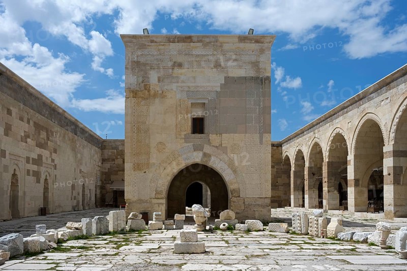 Old courtyard with stone arches and scattered ruins under a clear sky, Sultanhani caravanserai, on the former Silk Road, museum, Sultanhani Kervansaray, Sultanhani, Aksaray province, Turkey