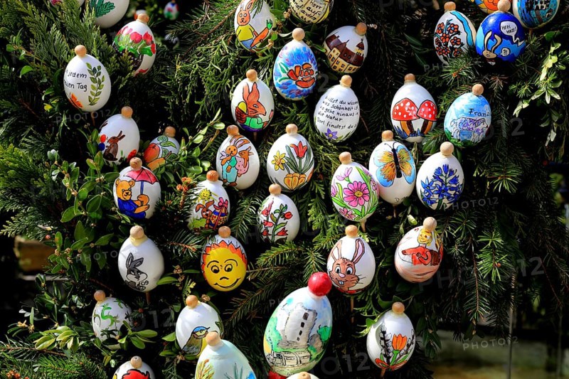 Detail, eggs painted by children, comic characters, Easter fountain in Heiligenstadt, Franconian Switzerland, Bamberg district, Upper Franconia, Bavaria, Germany, colorful, painted Easter eggs hanging on a tree, festive and happy atmosphere in nature