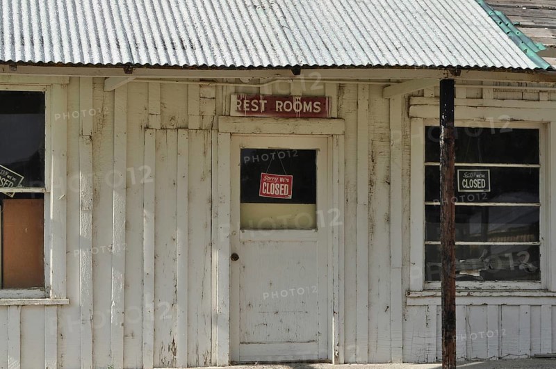 Old white door with 'Rest Rooms and Sorry We're Closed' signs on a wooden building, Stratton's Store, Unity, Oregon, USA