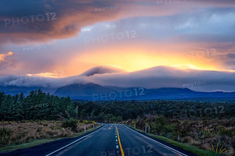 Mount Ngauruhoe in the morning at sunrise with glowing clouds, road SH 47. Tongariro National Park, North Island, New Zealand