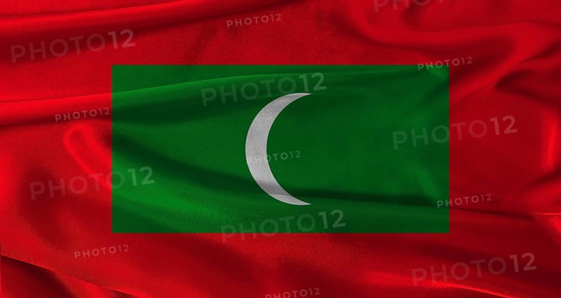 Flag of Maldives with fabric textured background. Close up of National flag of Maldives with realistic texture