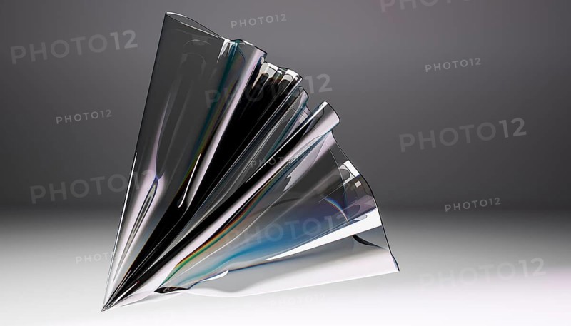 A captivating abstract sculpture crafted from glass, showcasing intricate folds and dynamic reflections. The elegant interplay of light and shadow creates a mesmerizing visual experience