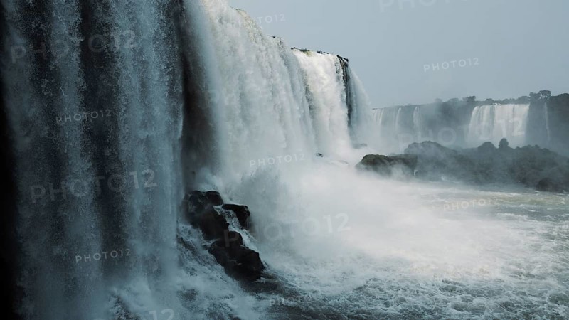 Stunning capture of the powerful Iguazu Falls surrounded by mist and plunging into the river at the border of Argentina and Brazil