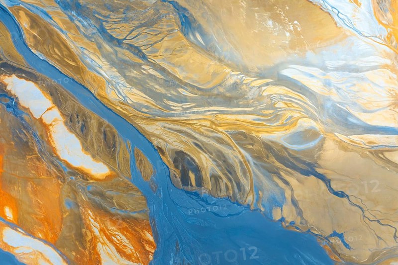 This image captures the stunning multicolour abstract view of a landscape from aerial photography, featuring vibrant flows and contours