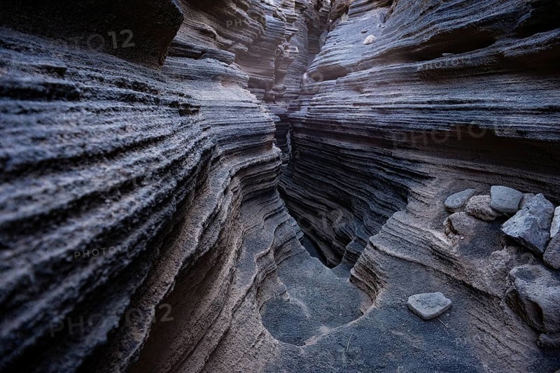 Intricate volcanic rock formations showcasing layered textures inside the popular natural cave in Lanzarote, Canary Islands