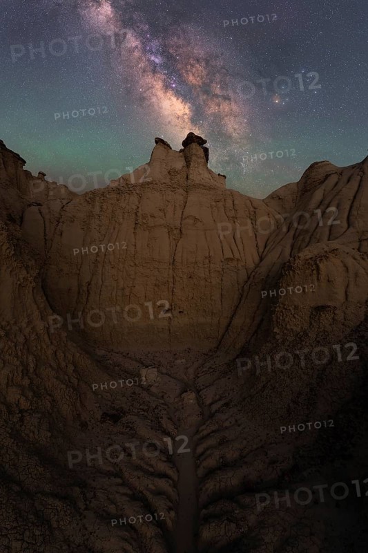 Captivating view of the Milky Way stretching above the unique sandstone formations in Goblin Valley State Park, Utah, highlighting the tranquil beauty of the night sky