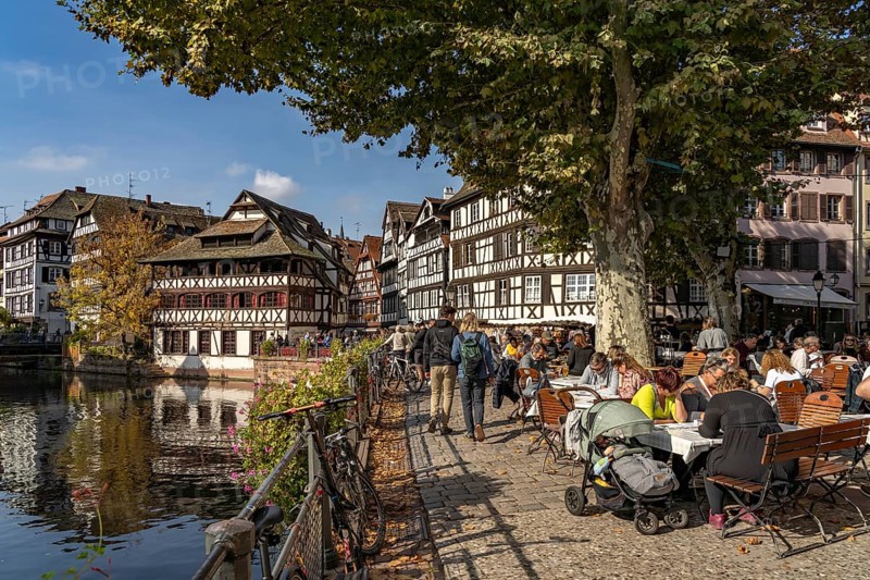 Busy cafe on Place Benjamin Zix and the Maison des Tanneurs half-timbered house in Petite France, Strasbourg, Alsace, France