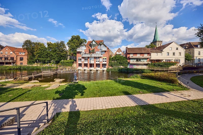 Mühlenstever, Stever river, houses, residential buildings, church tower of St. Felizitas, green area, lawn, paths, wooden walkway, trees, blue sky, cumulus clouds, Borg, Borgmühlenpättken, Lüdinghausen, Münsterland, Coesfeld district, North Rhine-Westphalia, Germany