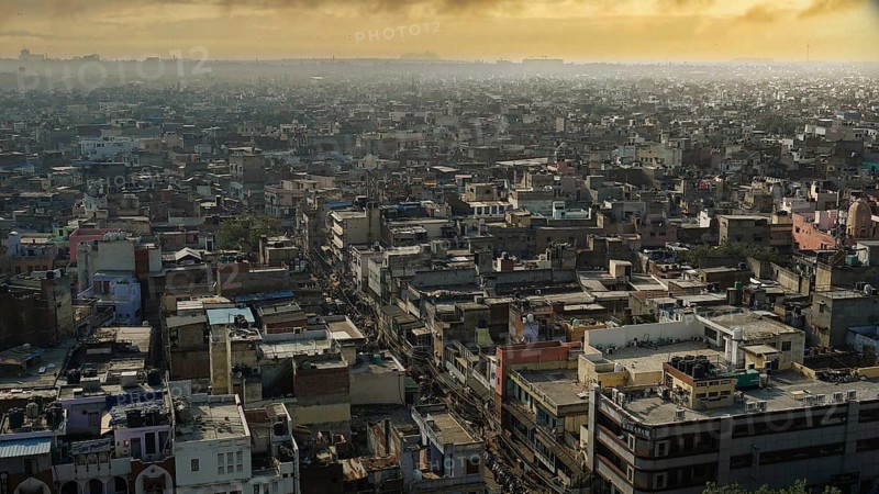 View of the rooftops of an expansive cityscape at sunset, Delhi, India