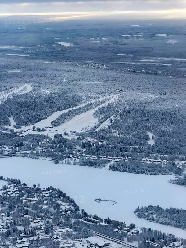 View of the snowy town of Rovaniemi with the Kemijoki river, in winter, aerial view, Finland