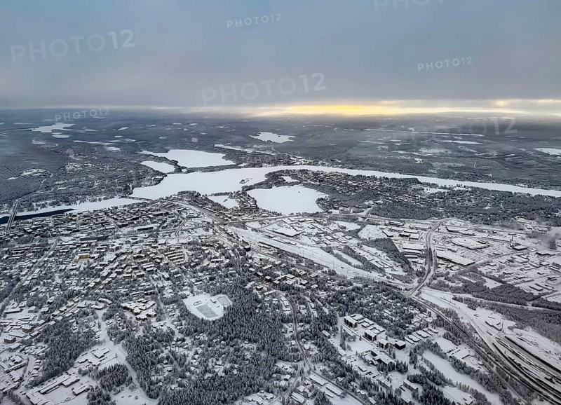 View of the snowy town of Rovaniemi with the Kemijoki river, in winter, aerial view, Finland