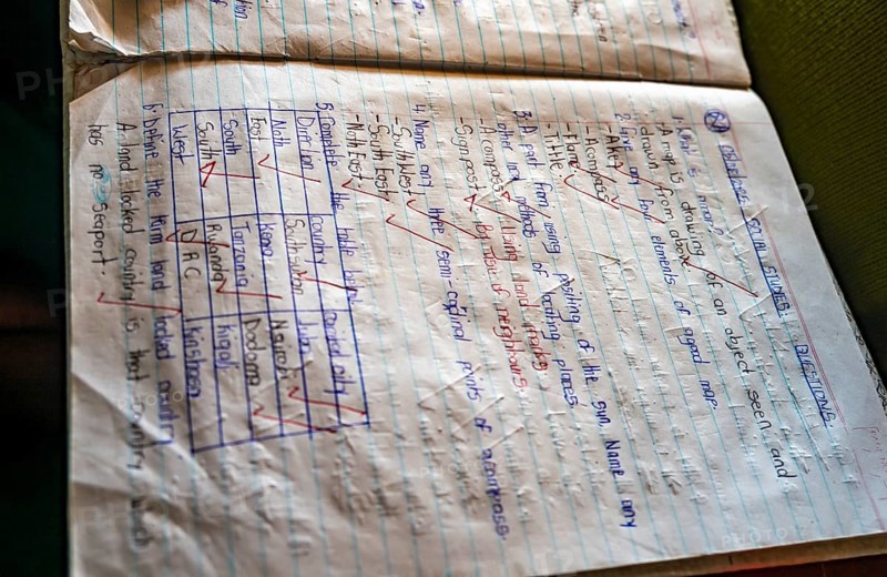Neatly described school notebook with corrected homework, school, Rushaga, Western Region, Uganda