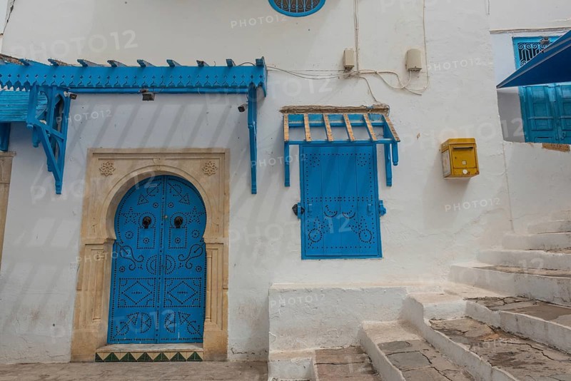 Authentic blue coloured architecture of the Tunisian cliff top village of Sidi Bou Said, overlooking historical Carthage and the Gulf of Tunis. Tunisia