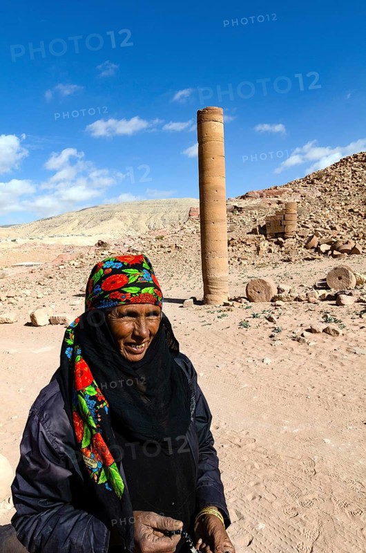 Petra, Jordan. December 11th 2012. A Jordanian Bedouin woman near a monument known as the Pharaohs Penis, Petra, Jordan