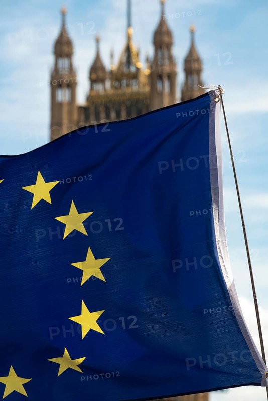 European flag with the British Houses of Parliament, the seat of the UK government in Westminster, London, England, United Kingdom