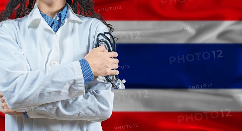 Healthcare professional with Thailand flag background. Professional doctor holding stethoscope on Thailand flag background