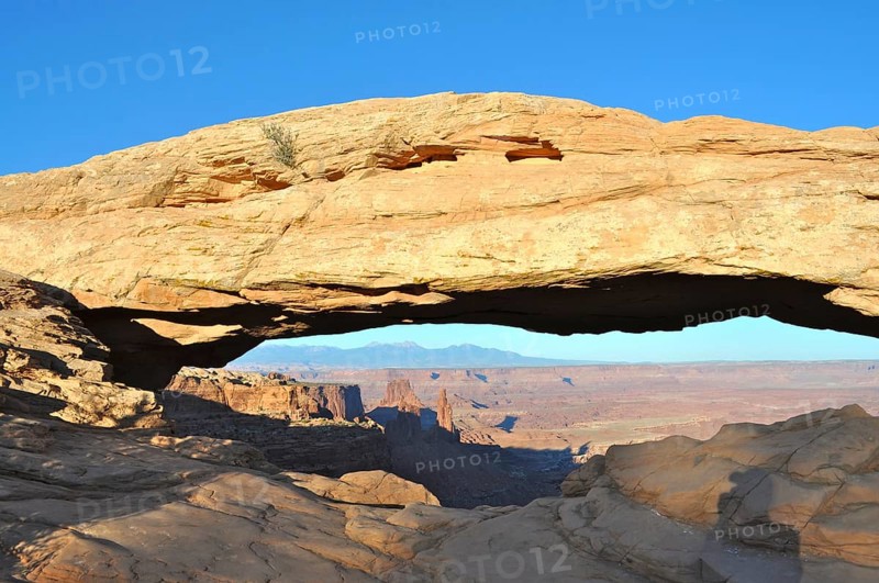 Impressive Mesa Arch rock arch over the vast desert landscape, Canyonlands National Park, Island in the Sky, Utah, USA