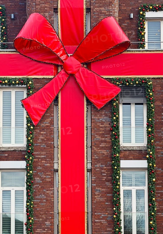 Large red ribbon on a house façade in the run-up to Christmas, Roermond, Limburg province, the Netherlands