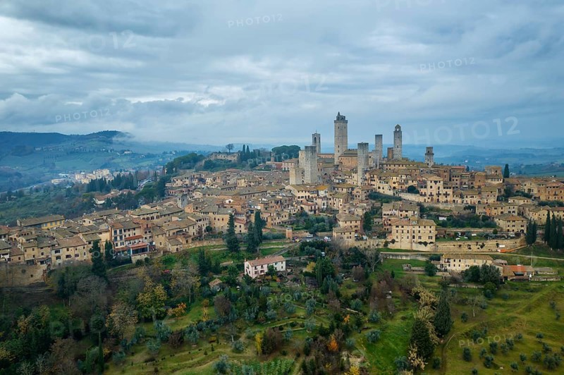 A captivating aerial view of San Gimignano, the historic hilltop town in Tuscany, Italy, famed for its medieval towers, stone buildings, and scenic countryside
