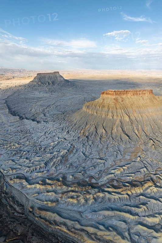 Stunning aerial view of Caineville Mesa, Utah, USA Capturing the majestic landscape, rugged contours, and dramatic shadow play under a vast blue sky