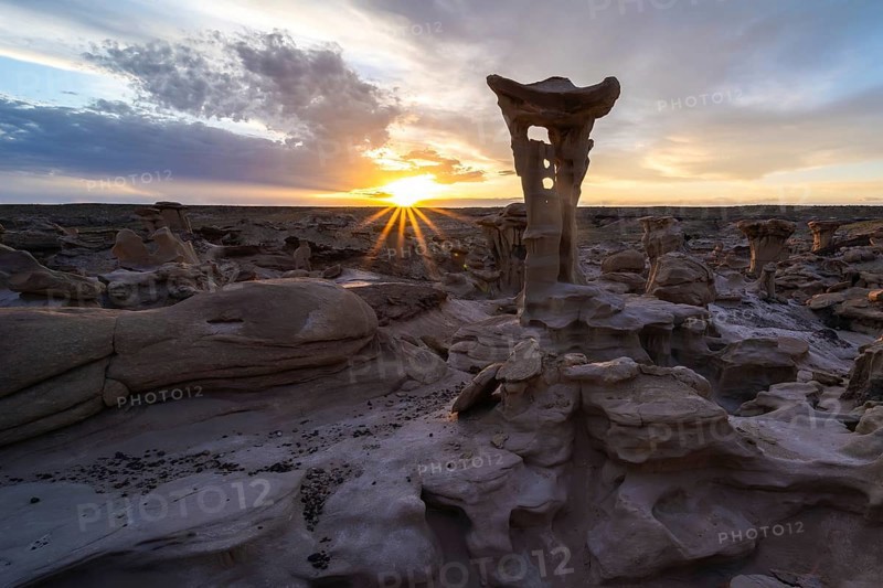 Captivating sunrise over unique hoodoo formations in Bisti De-Na-Zin Wilderness, New Mexico, USA Dramatic sky and desert landscape create an ethereal natural scene