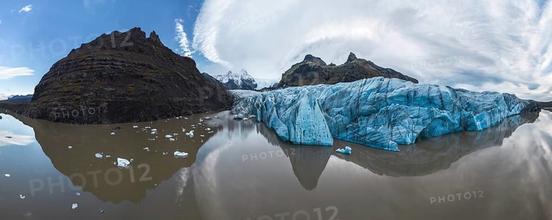 Panoramic view of Vatnajokull National Park's stunning ice formations, rugged mountains, and serene reflections Captures Iceland's pristine natural beauty and dramatic landscape